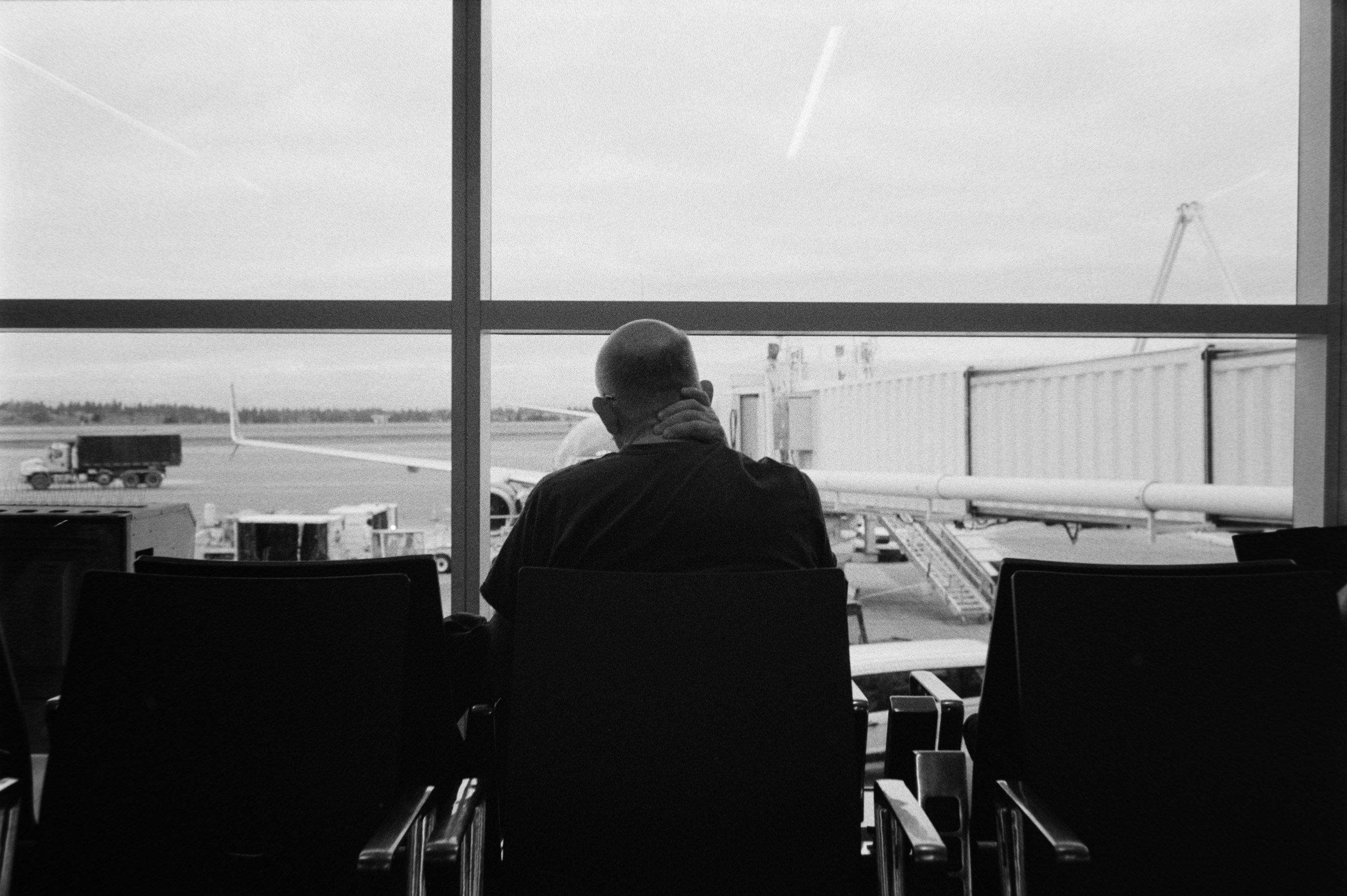 A traveler waiting by the airport window